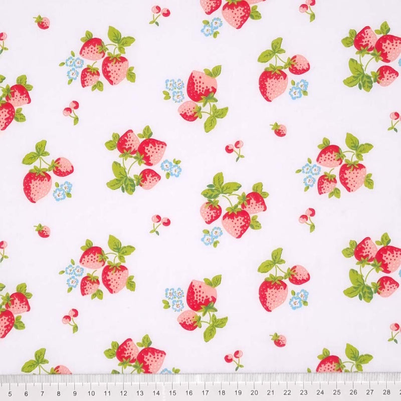 Red strawberries are printed on a white polycotton fabric with a cm ruler at the bottom