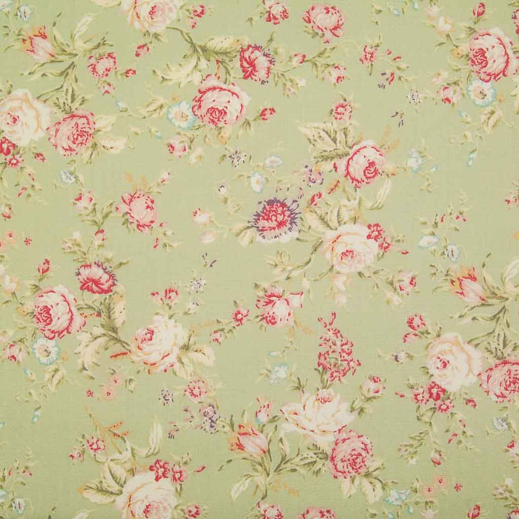 A floral pattern of pink and pale roses on a green fat quarter of Rose & Hubble cotton poplin fabric