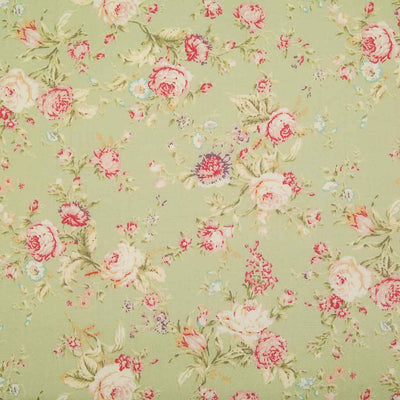 A floral pattern of pink and pale roses on a green fat quarter of Rose & Hubble cotton poplin fabric