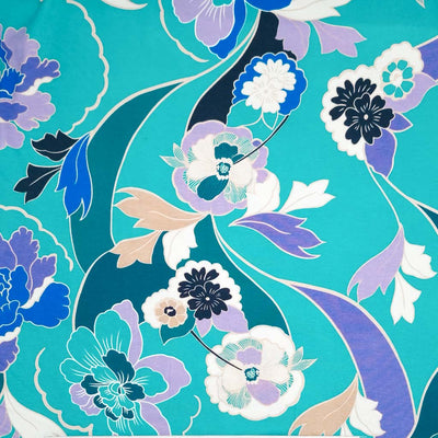 A beautiful lilac, emerald and blue floral print on a turquoise viscose jersey fabric
