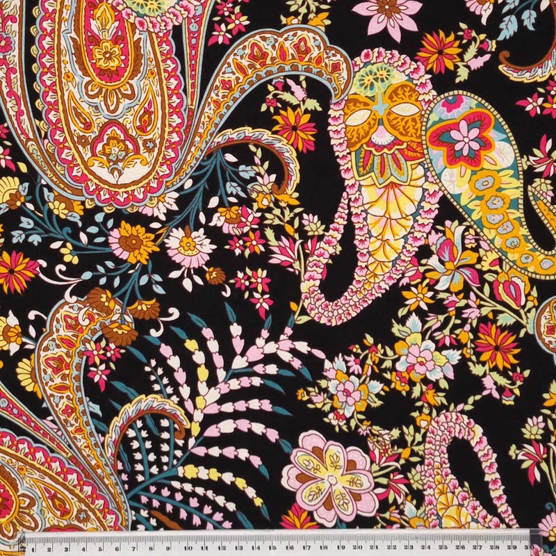 A beautiful paisley floral print in a black, orange and pink colourway on a viscose jersey fabric with a cm ruler