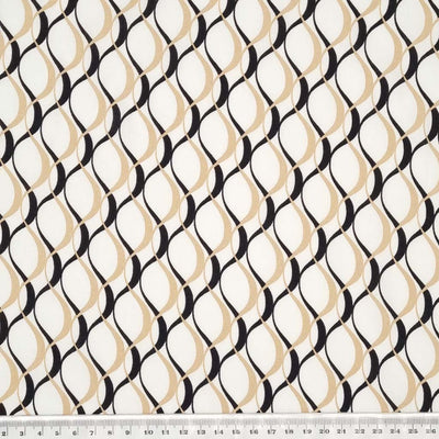 A classic sand and black coloured wave design on a white, 100% viscose challis fabric with a cm ruler
