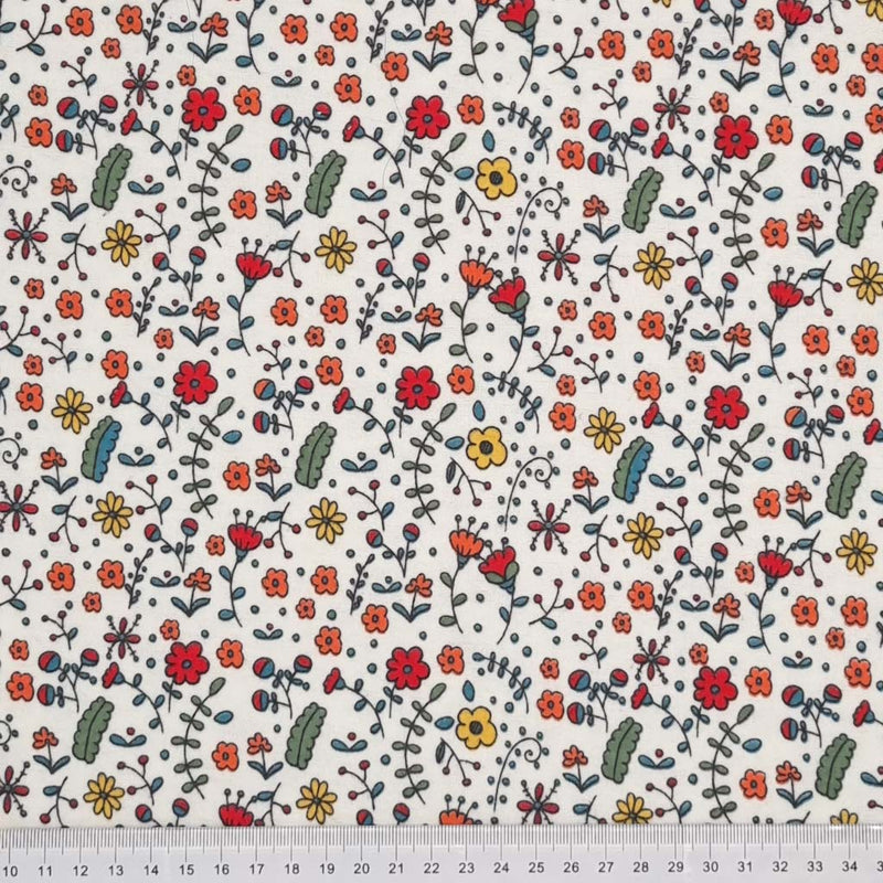 A funky floral design in red, orange and green, printed on a white, soft brushed polycotton winceyette with a cm ruler at the bottom