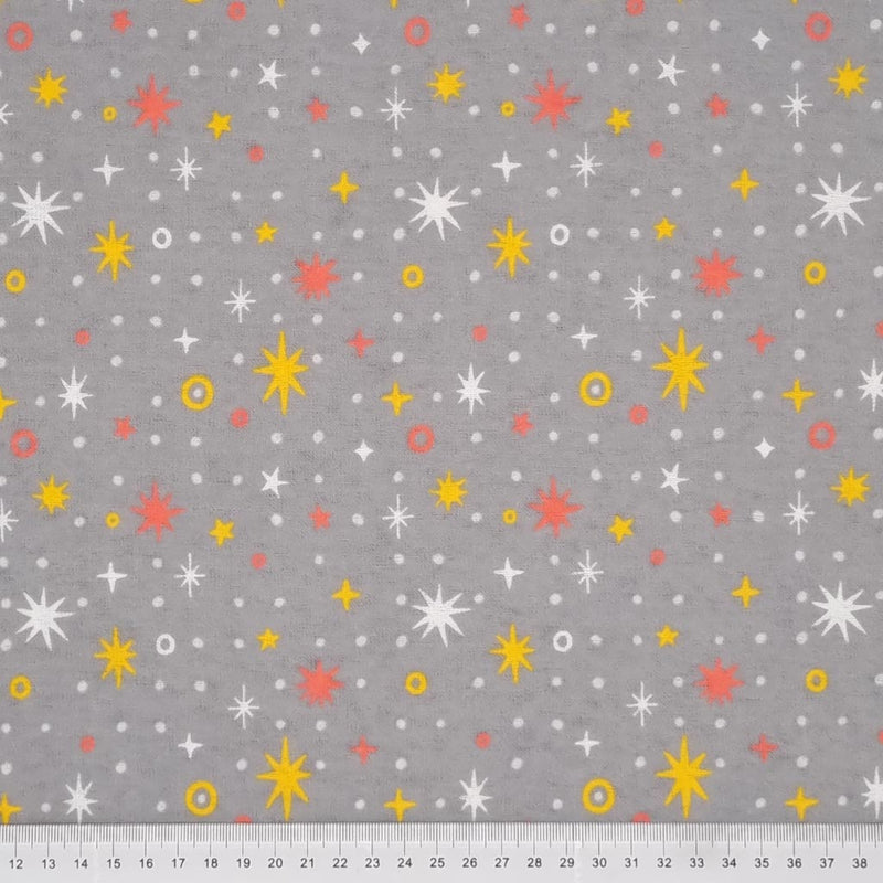 Sparkle stars in yellow and white printed on a grey, soft brushed polycotton winceyette with a cm ruler at the bottom