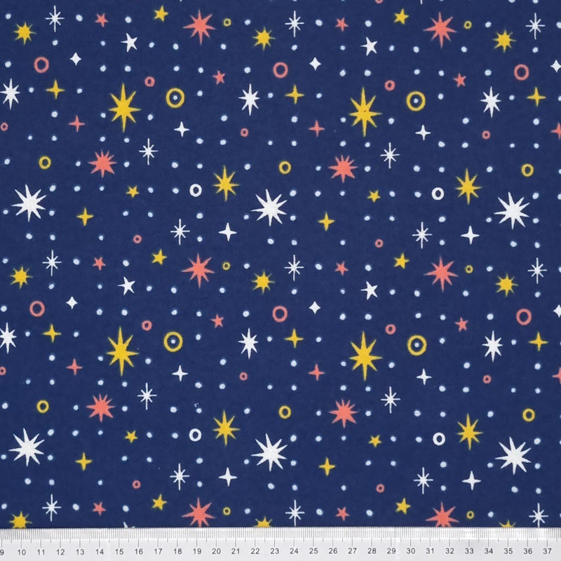 Sparkle stars on yellow and white printed on a navy, soft brushed polycotton winceyette with a cm ruler at the bottom