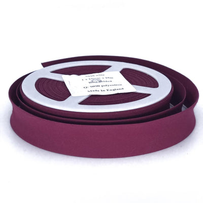 A reel of wine coloured 25mm bias binding